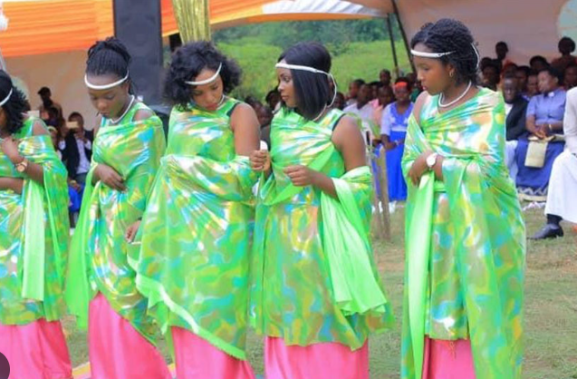 Batooro people in traditional attire performing cultural dance during a vibrant Ugandan ceremony.