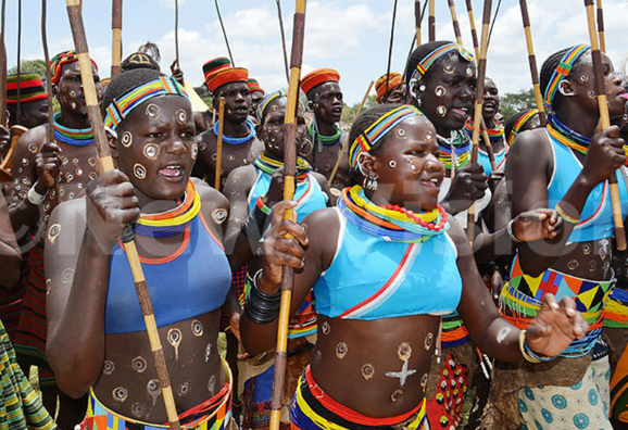 Karimojong people in traditional attire showcasing culture and heritage values.
