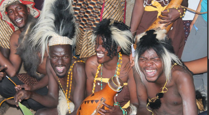 Sebei people in Uganda performing traditional dances wearing colorful cultural attire outdoors.